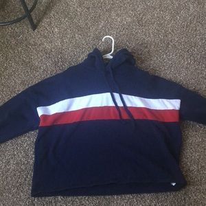 Navy blue hoodie with red and white middle stripe